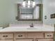 Bathroom with modern vanity, decorative mirror, and neutral color scheme at 811 Gazebo Way, Greenwood, IN 46142