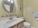 Bathroom featuring a decorative framed mirror, and a sink with tiled backsplash at 811 Gazebo Way, Greenwood, IN 46142