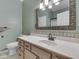 Bathroom with modern vanity, decorative mirror, and neutral color scheme at 811 Gazebo Way, Greenwood, IN 46142
