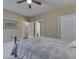Bedroom with neutral walls, carpet, ceiling fan, and a bed with view to bathroom and closet at 811 Gazebo Way, Greenwood, IN 46142