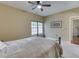 Bedroom with neutral walls, carpet, ceiling fan, and a bed with natural light from large window at 811 Gazebo Way, Greenwood, IN 46142
