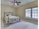 Bedroom featuring neutral carpet, a ceiling fan, a decorative bedframe and natural light through a large window at 811 Gazebo Way, Greenwood, IN 46142