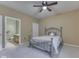 Bedroom with neutral walls, carpet, ceiling fan, and a decorative bedframe, with view into bathroom at 811 Gazebo Way, Greenwood, IN 46142