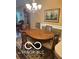 The dining room showcases elegant lighting and a well-crafted wooden table with six chairs at 811 Gazebo Way, Greenwood, IN 46142