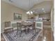 Elegant dining room with wooden table and chairs adjacent to kitchen at 811 Gazebo Way, Greenwood, IN 46142