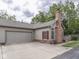 Exterior of home featuring a two-car garage, brick chimney, and well-maintained landscaping at 811 Gazebo Way, Greenwood, IN 46142