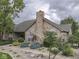 Stone clubhouse with mature landscaping, decorative rocks, and charming architectural details at 811 Gazebo Way, Greenwood, IN 46142