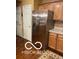 Stainless steel refrigerator complementing the wooden cabinetry and adjacent white doors at 811 Gazebo Way, Greenwood, IN 46142