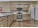 Kitchen with stainless steel appliances and light wood cabinets at 811 Gazebo Way, Greenwood, IN 46142