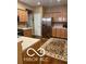 The kitchen features wooden cabinets, a stainless steel refrigerator, and a patterned floor rug at 811 Gazebo Way, Greenwood, IN 46142
