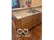 Functional kitchen area featuring wooden cabinetry, laminate countertop, and a double sink at 811 Gazebo Way, Greenwood, IN 46142