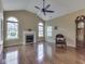 Living room boasts large windows, a fireplace, hardwood floors, and a vaulted ceiling at 811 Gazebo Way, Greenwood, IN 46142