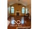 Spacious living room with vaulted ceiling, hardwood floors, fireplace, and large windows at 811 Gazebo Way, Greenwood, IN 46142