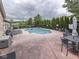 Community pool with lounge chairs, tables, and mature trees at 811 Gazebo Way, Greenwood, IN 46142