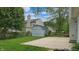 Backyard featuring a shed, concrete patio, partial fence, and green grass at 8121 Sand Ridge Cir, Indianapolis, IN 46237