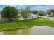 Aerial view of backyard featuring a pond and lush green lawns at 8121 Sand Ridge Cir, Indianapolis, IN 46237