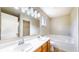 Bathroom with a double vanity, shower, soaking tub, and a window for natural light at 8121 Sand Ridge Cir, Indianapolis, IN 46237