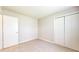 Carpeted bedroom features a door for privacy and a closet for storage at 8121 Sand Ridge Cir, Indianapolis, IN 46237