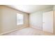 Carpeted bedroom features a window for natural light and a door for privacy at 8121 Sand Ridge Cir, Indianapolis, IN 46237