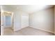 Carpeted bedroom features a closet for storage and easy access to another room at 8121 Sand Ridge Cir, Indianapolis, IN 46237
