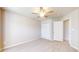 Neutral bedroom featuring carpeted floors, ceiling fan, and closet with bi-fold doors at 8121 Sand Ridge Cir, Indianapolis, IN 46237