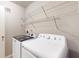 Functional laundry area with newer white washer and dryer units and overhead storage shelves at 8121 Sand Ridge Cir, Indianapolis, IN 46237