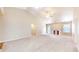 Open living room featuring neutral carpeting, vaulted ceilings, a fireplace, and ample natural light at 8121 Sand Ridge Cir, Indianapolis, IN 46237