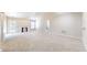 Spacious living room featuring neutral carpeting, a fireplace, and access to the backyard at 8121 Sand Ridge Cir, Indianapolis, IN 46237