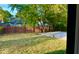 Spacious fenced backyard with concrete patio and mature trees, offering privacy at 8744 Montery Ct, Indianapolis, IN 46226