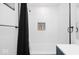Stylish bathroom featuring textured white tile, dark fixtures, and a convenient shower niche at 8744 Montery Ct, Indianapolis, IN 46226