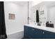 Modern bathroom features sleek blue vanity, stylish fixtures, and a tiled shower/tub at 8744 Montery Ct, Indianapolis, IN 46226