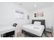 Comfortable bedroom with desk, large window, neutral tones, and a cozy gray bed frame at 8744 Montery Ct, Indianapolis, IN 46226