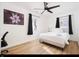 Well-lit bedroom features hardwood floors, ceiling fan, and a large flower art piece at 8744 Montery Ct, Indianapolis, IN 46226