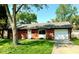 Charming single-story brick home with well-manicured lawn and attached garage at 8744 Montery Ct, Indianapolis, IN 46226