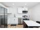 Modern kitchen features stainless steel appliances, white cabinets, and quartz countertops at 8744 Montery Ct, Indianapolis, IN 46226