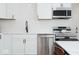 Modern kitchen features stainless steel appliances, white cabinets, and quartz countertops at 8744 Montery Ct, Indianapolis, IN 46226