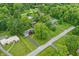 Aerial view of the property showing lush surroundings, mature trees, and a well-maintained landscape at 8752 Washington Blvd E Dr, Indianapolis, IN 46240