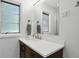 Bright bathroom features updated vanity with drawers and a window offering natural light and ventilation at 8752 Washington Blvd E Dr, Indianapolis, IN 46240