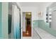 Bathroom featuring shower, view into hall, and vanity with granite countertop at 8752 Washington Blvd E Dr, Indianapolis, IN 46240