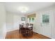 Cozy dining room with hardwood floors, wainscoting, and a view of the backyard at 8752 Washington Blvd E Dr, Indianapolis, IN 46240