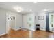 Bright foyer with hardwood flooring, a glass-accented front door, and neutral paint at 8752 Washington Blvd E Dr, Indianapolis, IN 46240