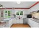 Bright kitchen with stainless steel appliances, white cabinetry, and a breakfast bar with stools at 8752 Washington Blvd E Dr, Indianapolis, IN 46240