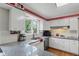 Updated kitchen with white cabinets, stainless steel appliances, and subway tile backsplash at 8752 Washington Blvd E Dr, Indianapolis, IN 46240