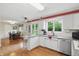 Spacious kitchen with white cabinets, stainless appliances, with breakfast bar, open to dining area at 8752 Washington Blvd E Dr, Indianapolis, IN 46240