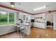 Light-filled kitchen featuring white cabinets, stainless appliances, and a breakfast bar with seating at 8752 Washington Blvd E Dr, Indianapolis, IN 46240