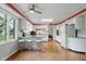Retro kitchen with white cabinets, stainless steel appliances, and red Coca-Cola trim and accents at 8752 Washington Blvd E Dr, Indianapolis, IN 46240