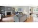 Bright living room with a fireplace, built-in shelving, hardwood floors, and comfortable seating at 8752 Washington Blvd E Dr, Indianapolis, IN 46240
