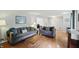 Comfortable living room with hardwood floors, neutral colors, and a large window for natural light at 8752 Washington Blvd E Dr, Indianapolis, IN 46240