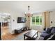 Cozy living room with a chandelier, large window, hardwood floors, and comfortable seating at 8752 Washington Blvd E Dr, Indianapolis, IN 46240