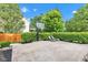 View of the large backyard featuring well maintained hedges, a basketball hoop, and lounge chairs at 8973 Carnation Dr, Noblesville, IN 46060
